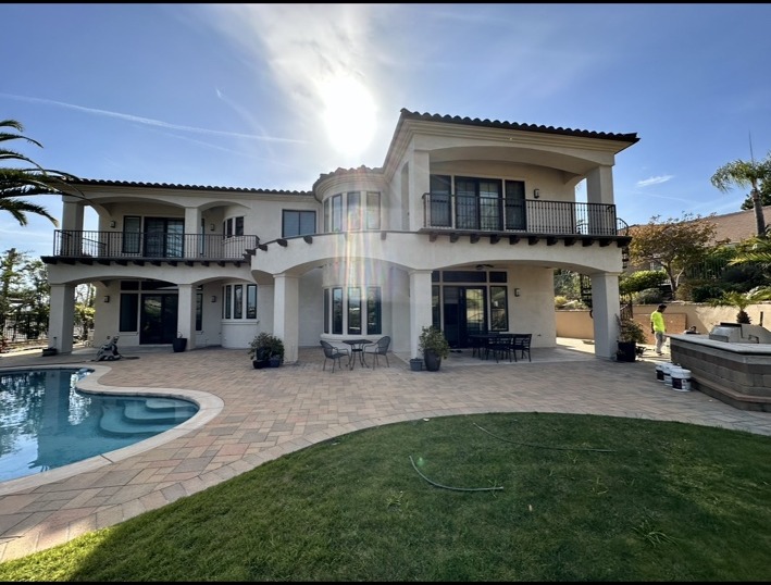 Large stucco residence and poolside patio