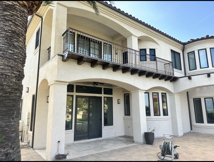 Close view of exterior wall, doors, windows and balcony