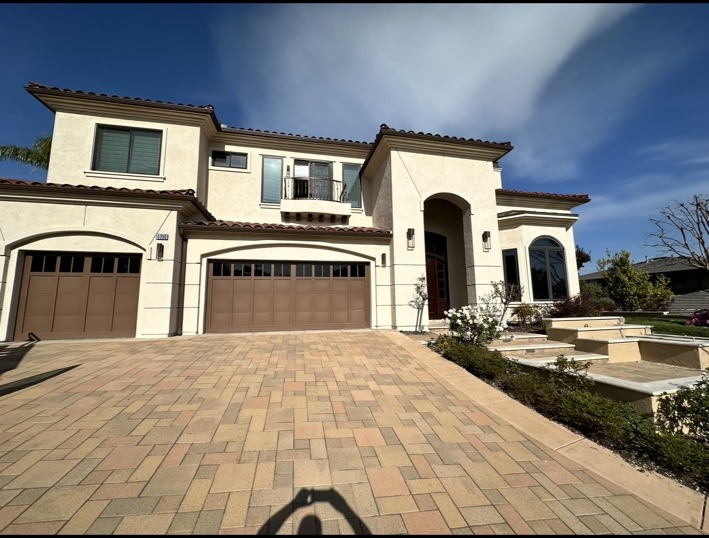 Residential home exterior with dark windows and garage doors