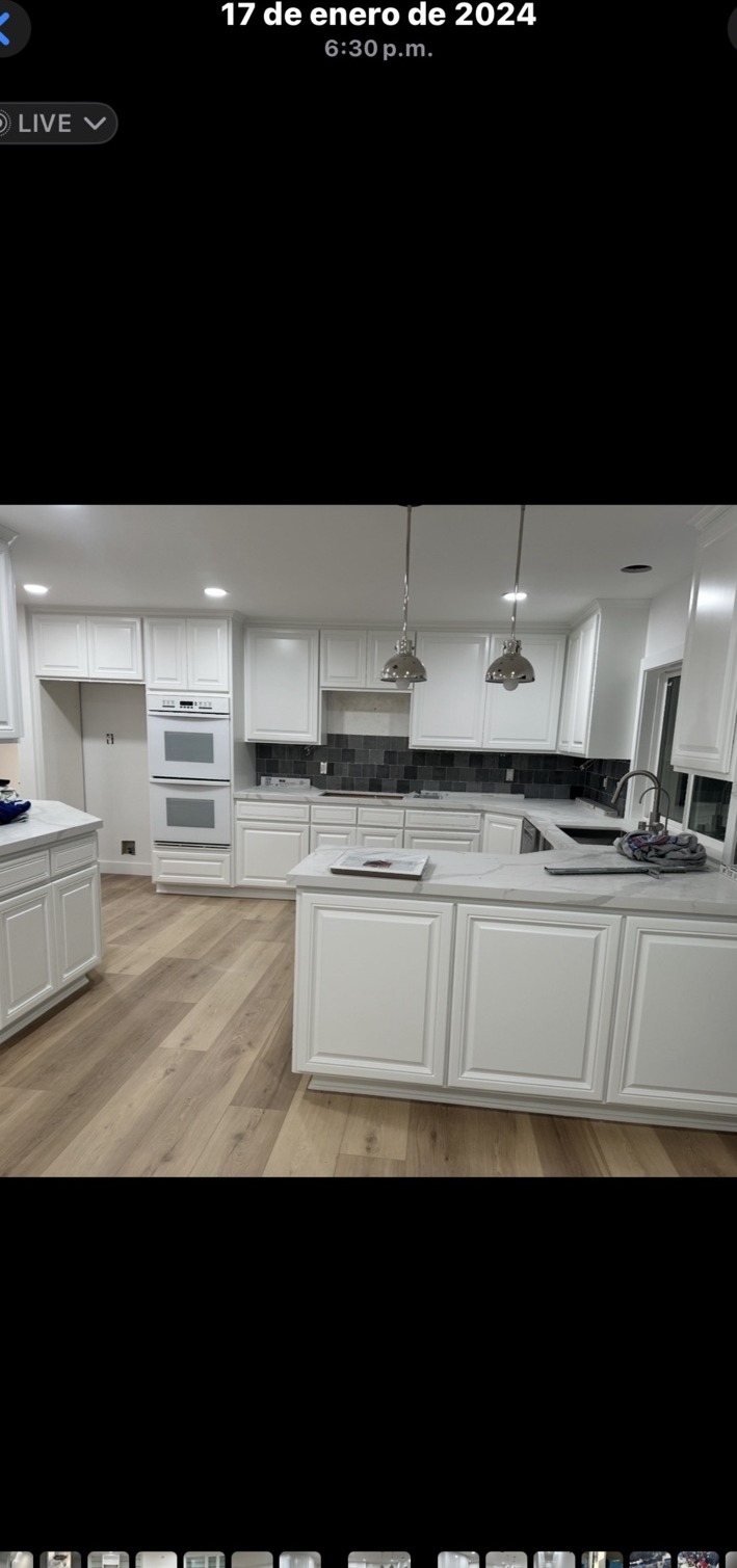 White kitchen cabinetry and contrasting backsplash